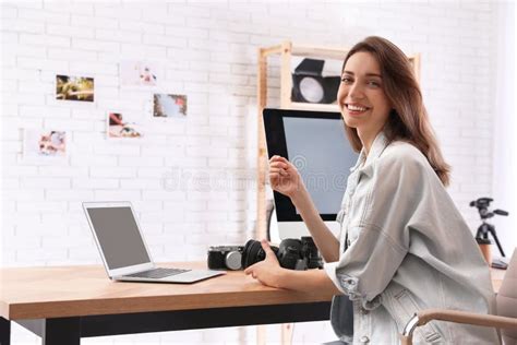 Professional Photographer With Camera Working At Table Stock Photo