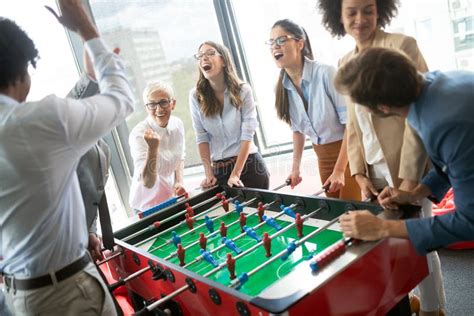 Excited Diverse Employees Enjoying Funny Activity At Work Break