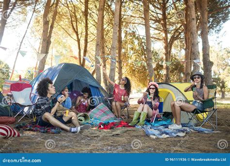 Young Friends Enjoying Together At Campsite Stock Photo Image Of