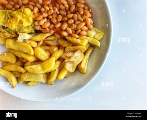 Battered Sausage Baked Beans And Chips For Lunch Stock Photo Alamy