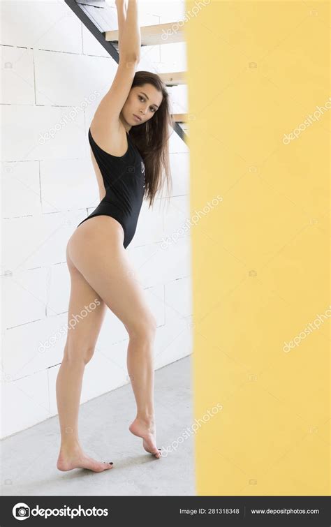 Beautiful Slender Woman In A Black Bodysuit Stock Photo By Airkost