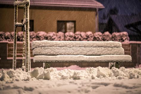 Bench With Snow After Snowstorm Or In Snow Calamity In Europe Winter