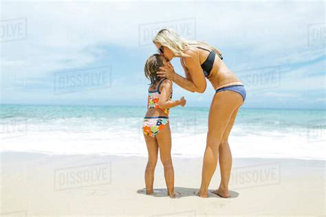 Mother Kissing Daughter 6 7 On Beach Stock Photo Dissolve