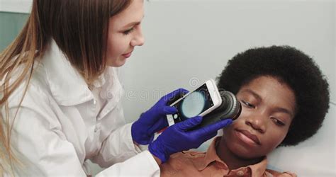 Close Up Of Doctor Dermatologist Examines A Birthmark Of Patient