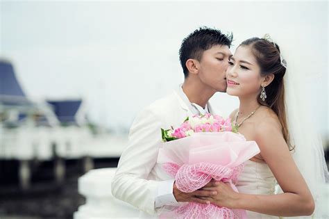 asian couple just marriage kiss in bridge photograph by anek suwannaphoom fine art america