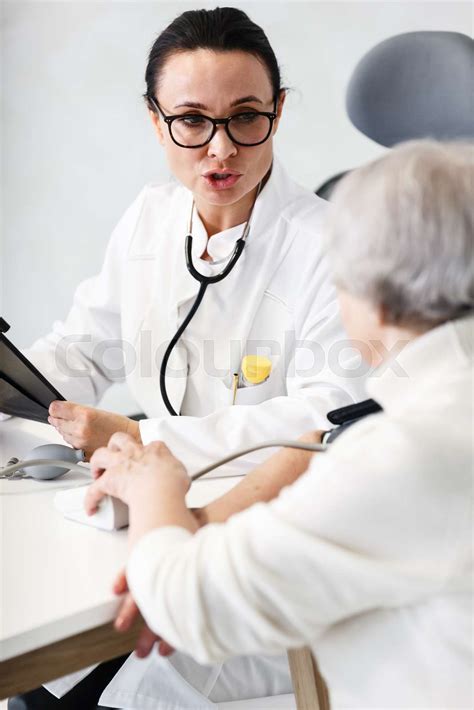 Healthcare In Hospital Concept Female Doctor Consulting Old Lady