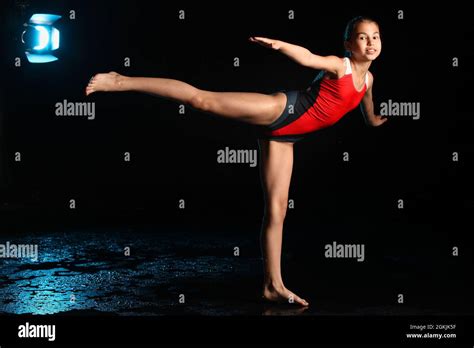 A Beautiful And Slender Teenage Girl In A Red One Piece Swimsuit Is