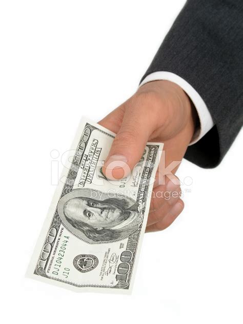 Businessmans Hand Offering One Hundred Dollar Bill Stock Photo