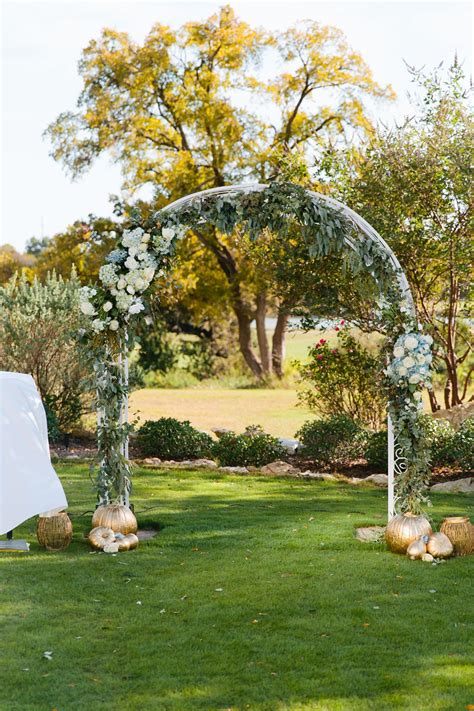 Outdoor Wedding Arch Draped With Hydrangeas Roses And Greenery