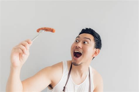 Premium Photo Happy Man Is Eating The Delicious Favorite Sausage He