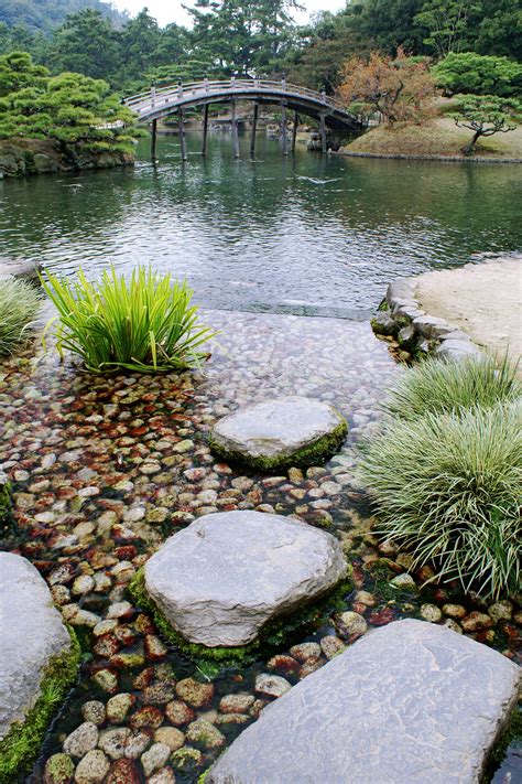 Carefully Positioned Stones Around The Pond In Ritsurin Garden
