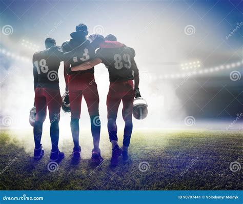 The Three American Football Players On On Stadium Background Stock