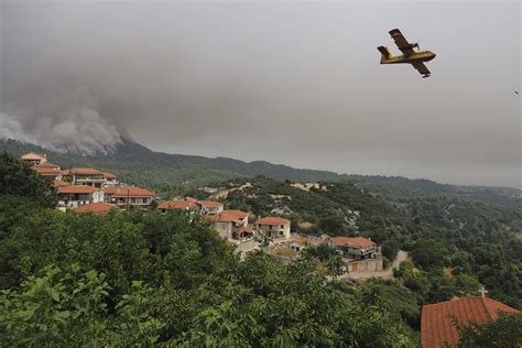 wildfires rage anew near athens forcing more evacuations in southern greece