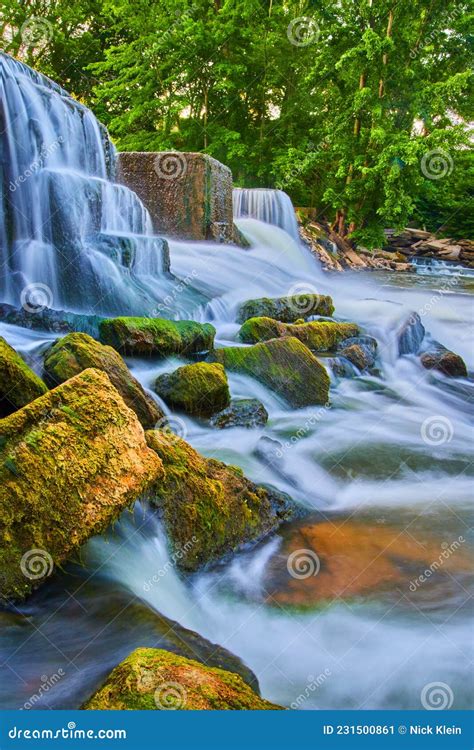 Waterfalls Crashing Around Small Algae Covered Rocks Stock Image