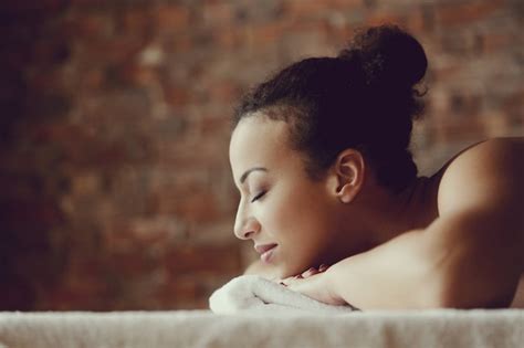 African American Woman Receiving A Relaxing Massage At The Spa Free Photo