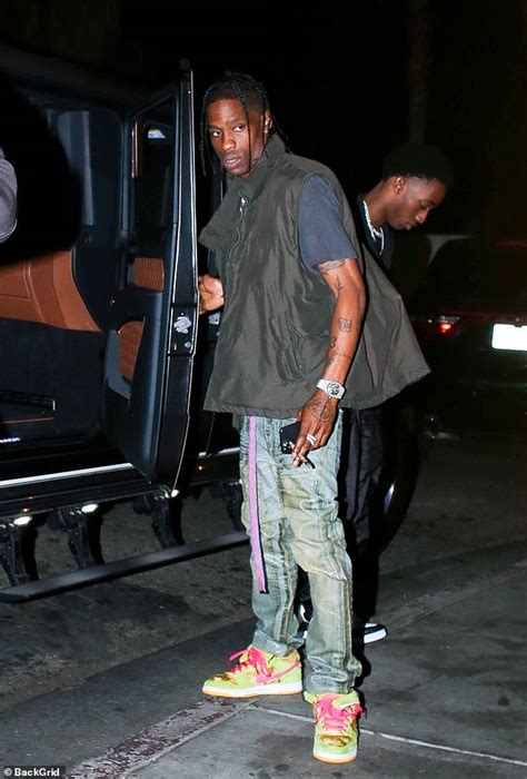 Travis Scott Is Spotted With A Mystery Woman Trailing Him During A