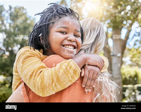 Mother Interracial Adoption And Carry Girl In Park In Summer Sunshine