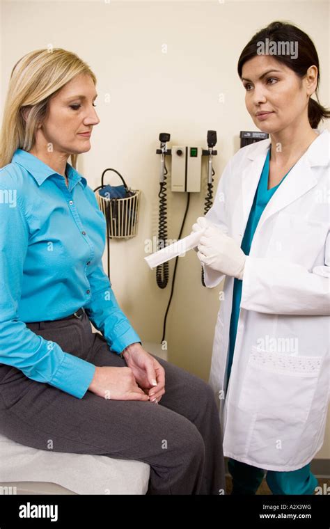 Female Patient Having A Physical Exam By A Female Doctor Stock Photo