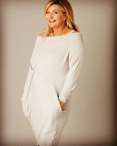 A Woman In A White Sweater Posing For The Camera