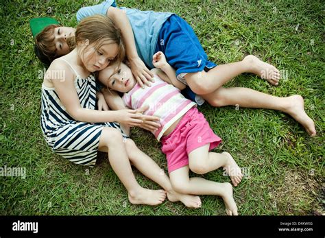 Children Laying In Grass Together Stock Photo Alamy