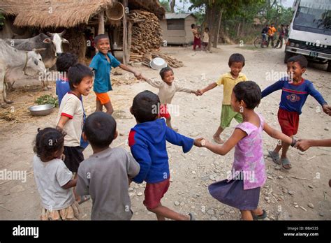 Young Children Playing In Street In Remote Village Chitwan National