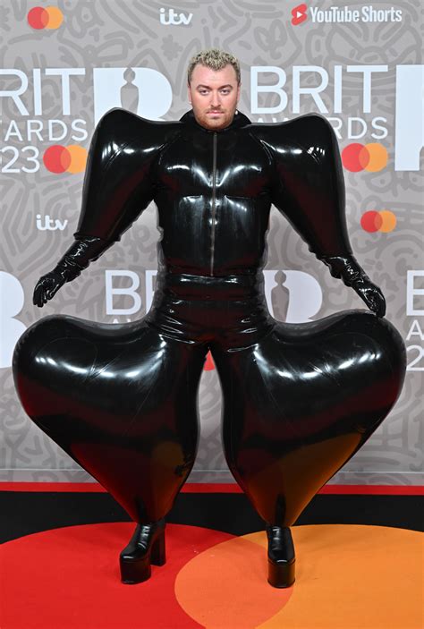 Sam Smith Bounces On Brit Awards Red Carpet In Latex Look By Harri