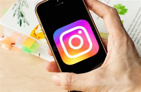 Hand Holding A Smartphone With An Instagram Icon On Screen Editorial