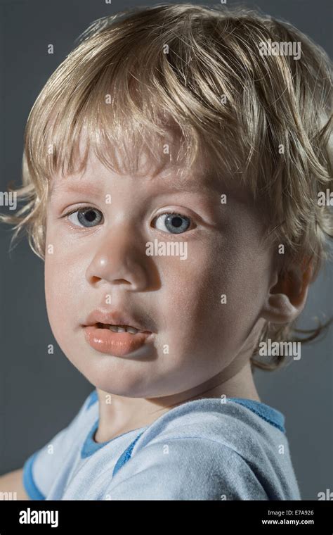 Portrait Of Cute Boy Over Gray Background Stock Photo Alamy