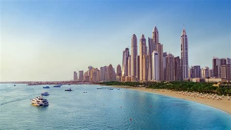 beach with boats near dubai marina with view on the skyline uae windows spotlight images