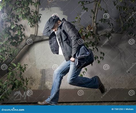 Man Running Away Along The Wall Stock Photo Image 7381250