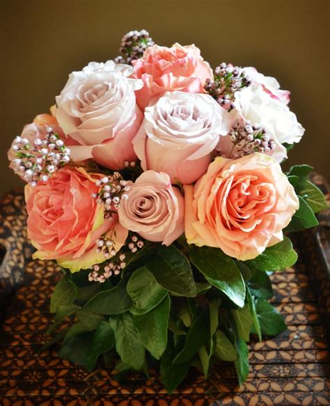 Pinkpeach Rose Bouquet With Waxflower Accent In A Natural Container