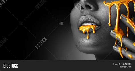 Gold Paint Smudges Drips From Woman Face Lips And Hand Lipgloss Dripping From Sexy Lips