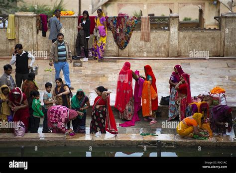 Some Indian Women In Traditional Indian Dress Sari Pray And Bathe In
