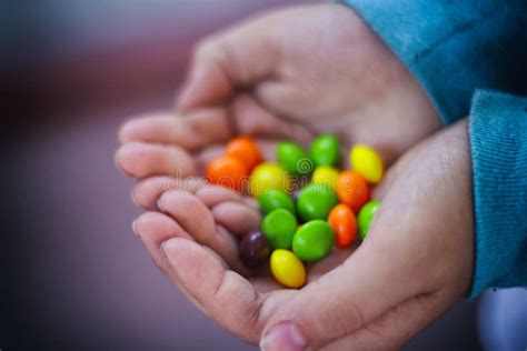 Human Hand Holding Colorful Candy Stock Photo Image Of Detail Orange