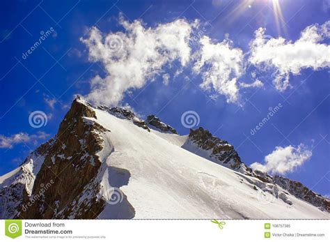 Closeup Icy And Snowy Mountain Peak With Cliff Ridge Stock Image