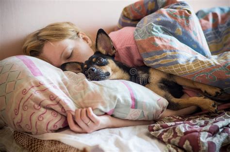 Woman And Her Dog Sleeping In The Bed Img