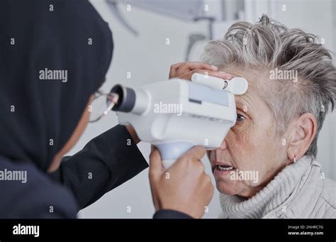 Optometrist Eye Test And Senior Woman Patient In Healthcare Checkup
