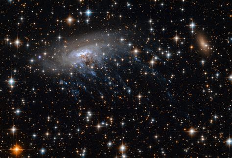 Hubble Telescope Captures Extraordinary Images Of A Galaxy Being Torn