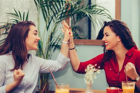 Happy Female Friends Are Giving High Celebrating Success While Looking Each Other Stock Image