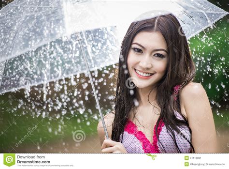 Beautiful Girl In The Rain With Transparent Umbrella Stock Photo