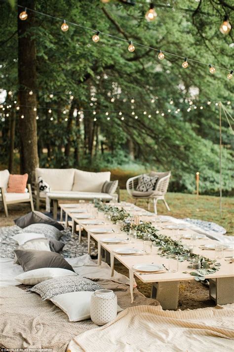 backyard picnic with fairy lights rustic picnic tables pretty table decorations and plenty of