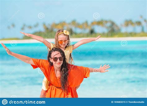 Beautiful Mother And Daughter At Caribbean Beach Enjoying Summer
