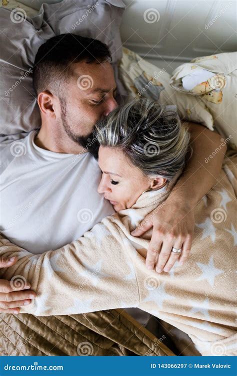Husband And Wife Sleeping Together In One Bed In Hug Stock Image