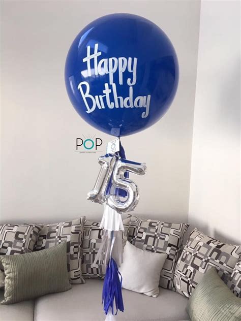 A Happy Birthday Balloon Sitting On Top Of A Couch