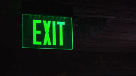 Exit Sign Illuminated In Dark Area Of Building 4k Stock Video Footage