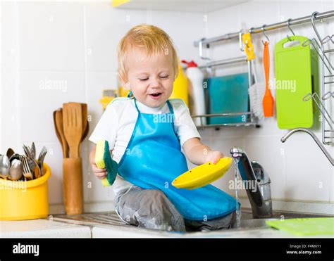 Toddler Boy Child Washing Up Kitchen Hi Res Stock Photography And