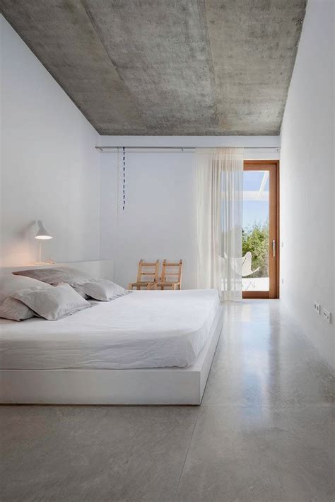 Photo 16 of 21 in a minimalist bungalow in miami welcomes a sleek new… bedroom, wall lighting, bed, concrete floor, and night stands the new addition features polished concrete floors. An In-Depth Guide To Polished Concrete Floors