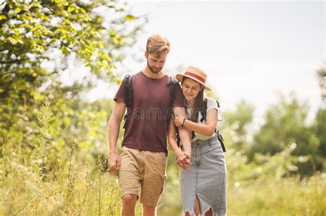 couple hiking along woodland path happy loving man and woman on holiday walking together