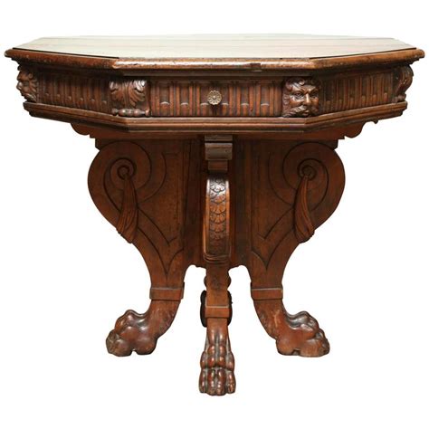 An antique 19th century italian centre table in walnut with a serpentine and moulded top, boldly carved scroll and leaf work to the frieze compliment the carved legs with claw and ball feet. Italian Renaissance Center Table at 1stdibs