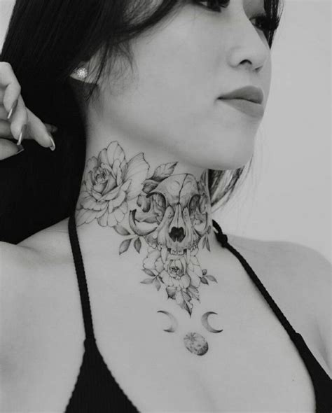 A Woman Wearing A Black Bra With Roses On Her Neck And Crescent Moon